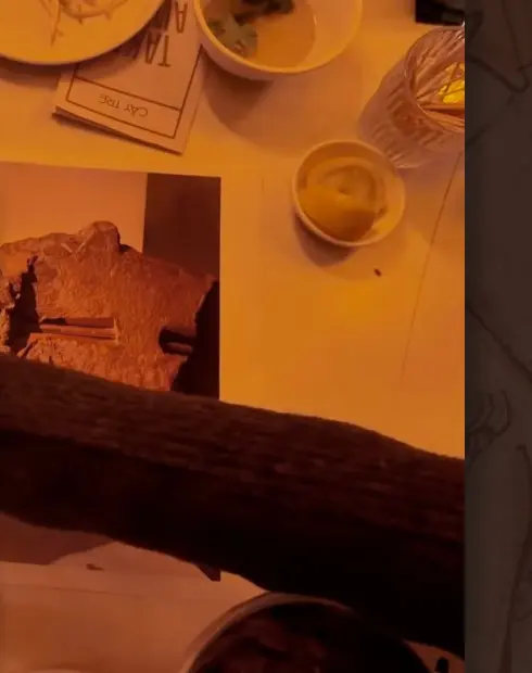 Hand interacting with an archival object