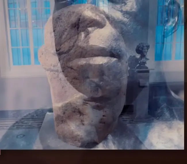 Stone head layered with architectural memory